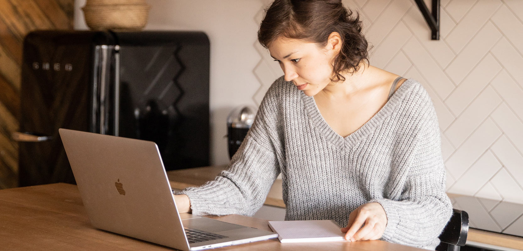 Freelance proofreader sitting at a desk and working on a laptop