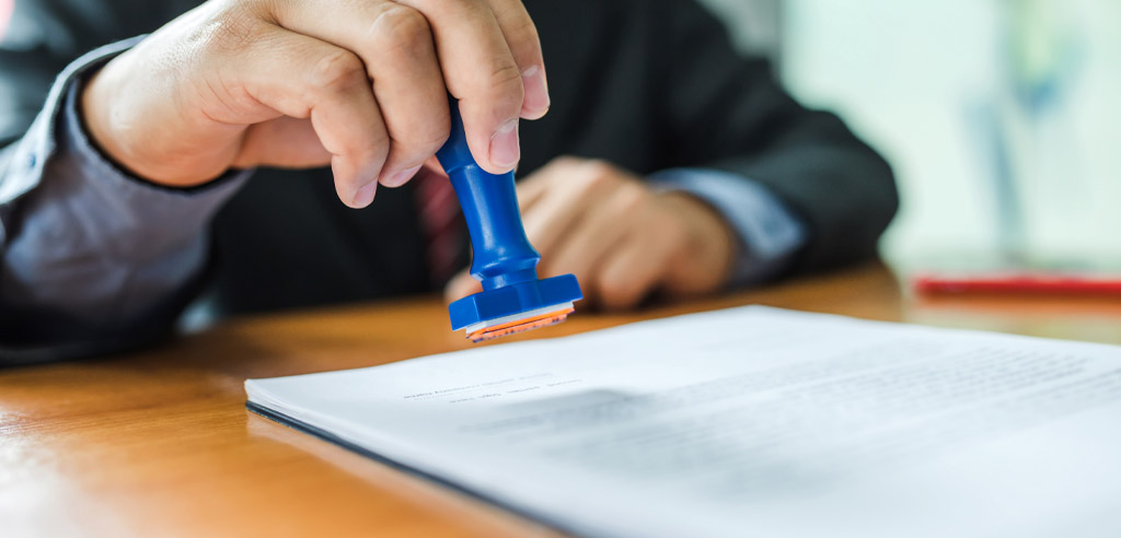 Mobile notary stamping a form for their side hustle