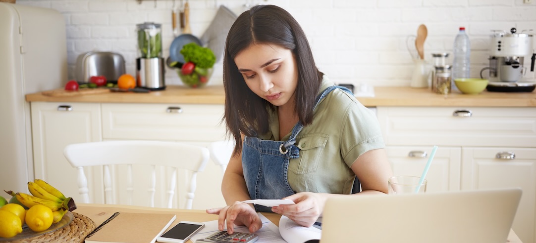 A woman calculating her living expenses.