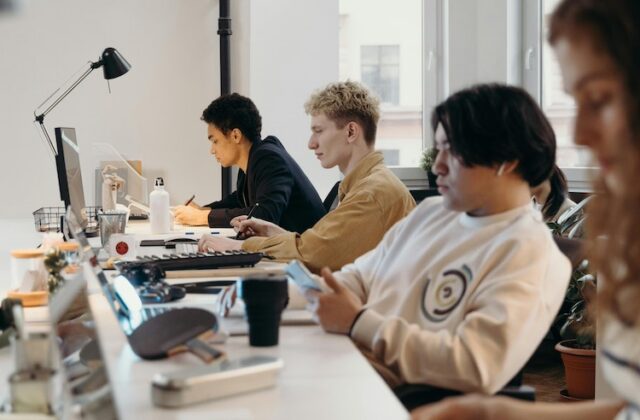 Four employees working in an office.